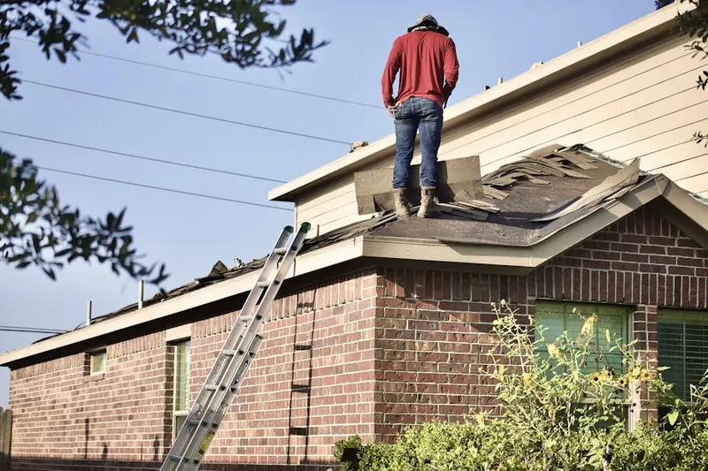 Professional roofer working on a residential roof in Thornton Heights
